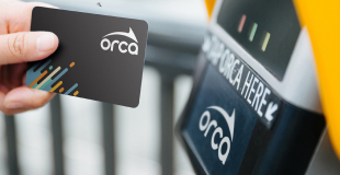 Close up of a person scanning an ORCA card at the reader