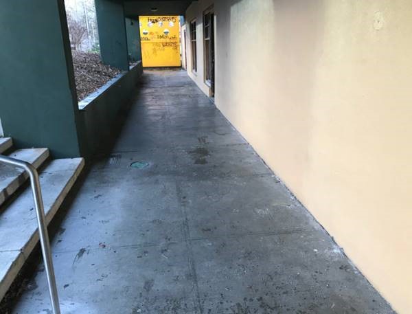 an outdoor breezeway cleaned of trash and freshly washed