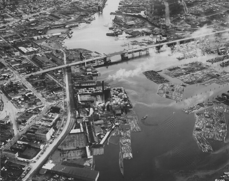 A black and white arial photo of the Ballard Bridge over Salmon Bay taken in 1950