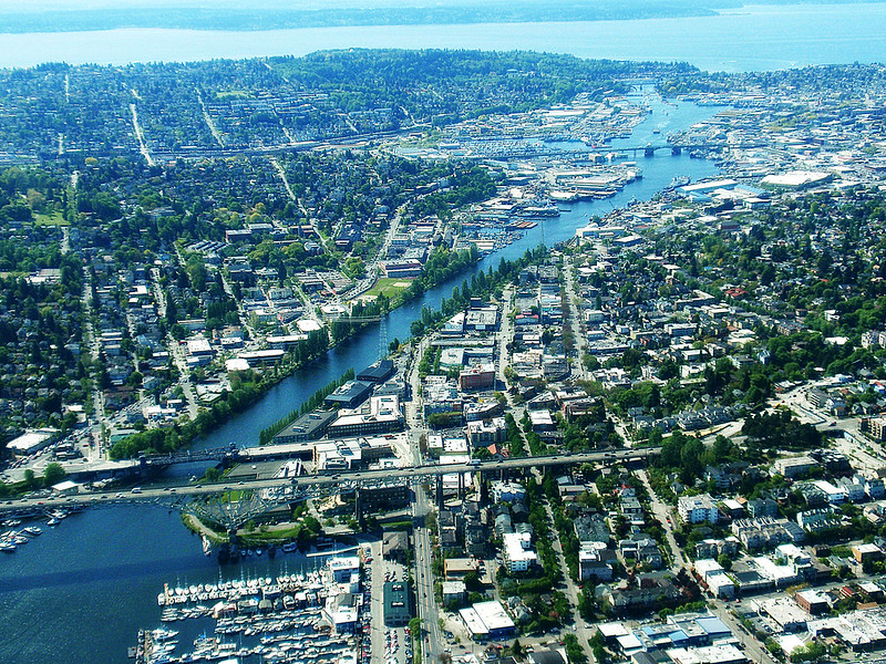 An arial photo taken above the Aurora, Fremont, and Ballard bridges, looking west