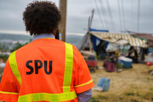 SPU employee examining an encampment.