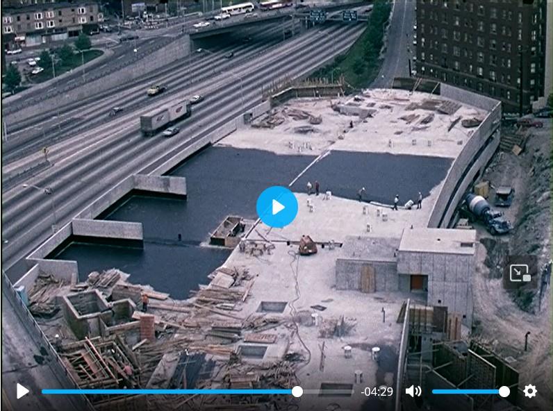 Screenshot from footage of Freeway Park and East Plaza Garage under construction in 1975-1976