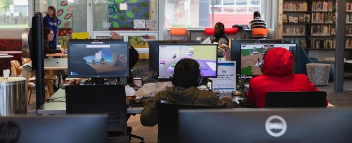 people using computers at a library