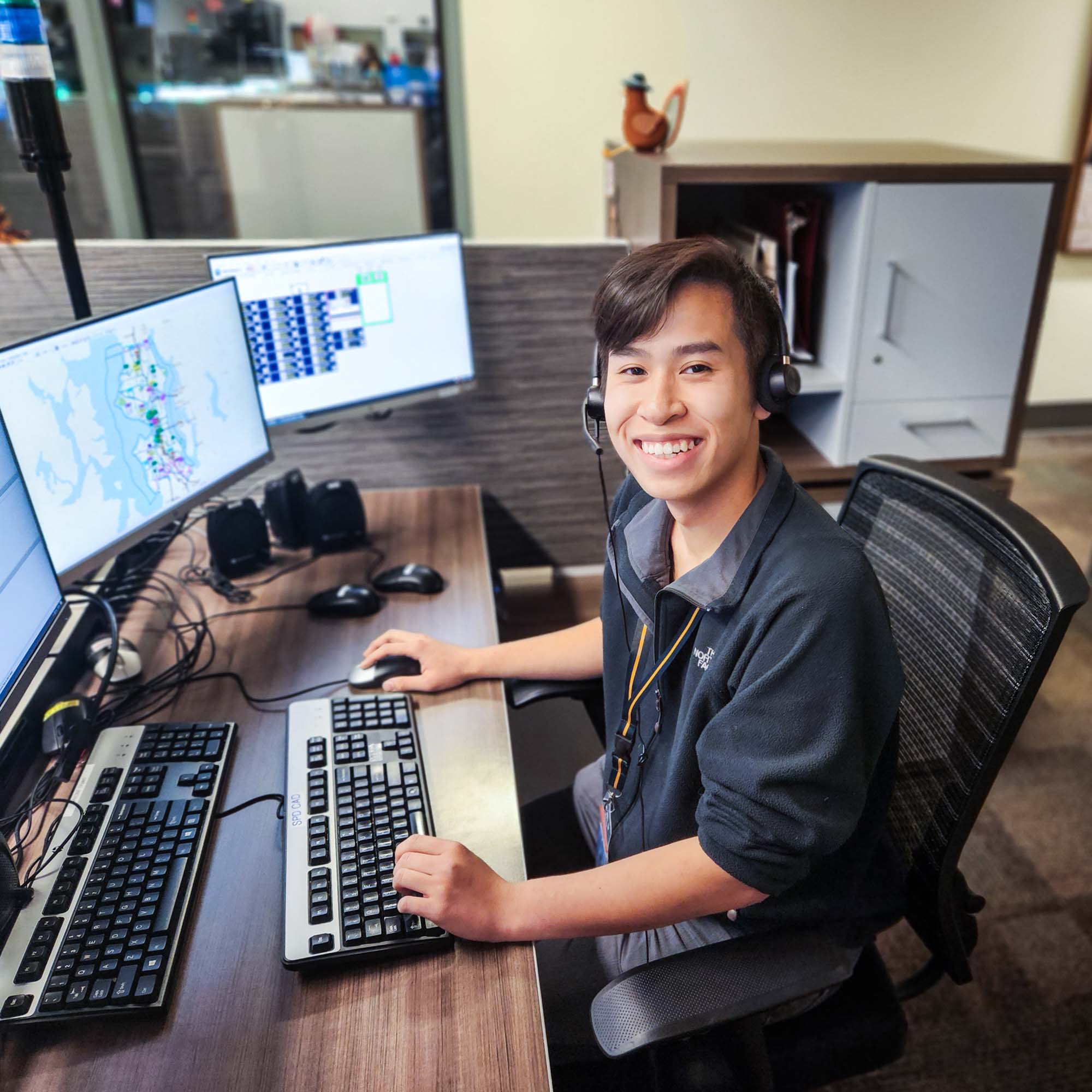 Dispatcher sitting at desk with monitors