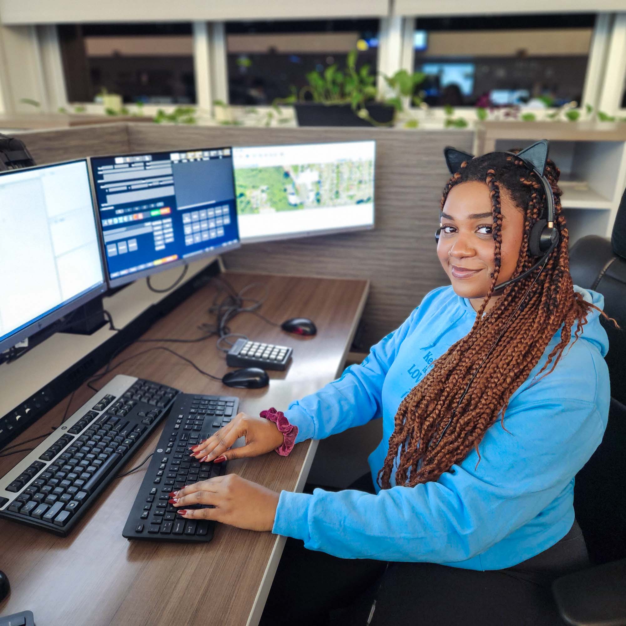 Dispatcher seated at desk with computer monitors