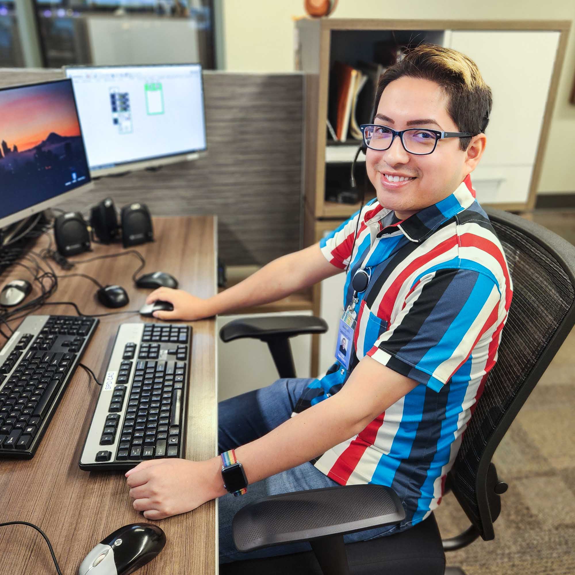 Dispatcher seated at desk with computer monitors