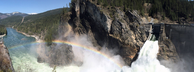 A rainbow forms over the rushing water at Boundary Dam