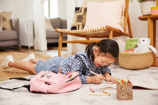 Preschooler learning at home on the floor