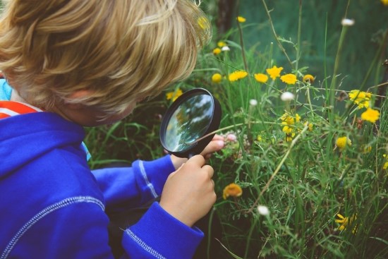 Child with Magnifying Glass Outside