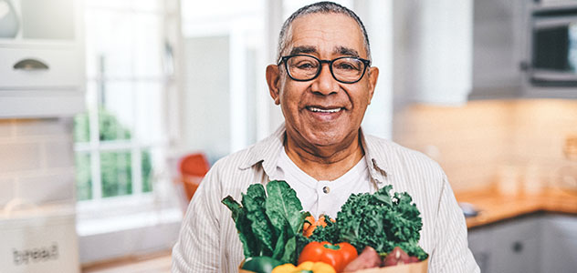 Man standing in a kitchen with groceries