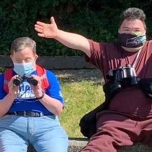 Two participants in Specialized Programs birdwatching