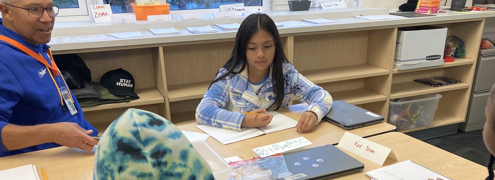 A child practices math at a Community Learning Center