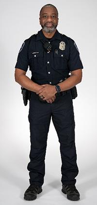 Seattle Police Officer standing against a blank background with a dark blue uniform shown