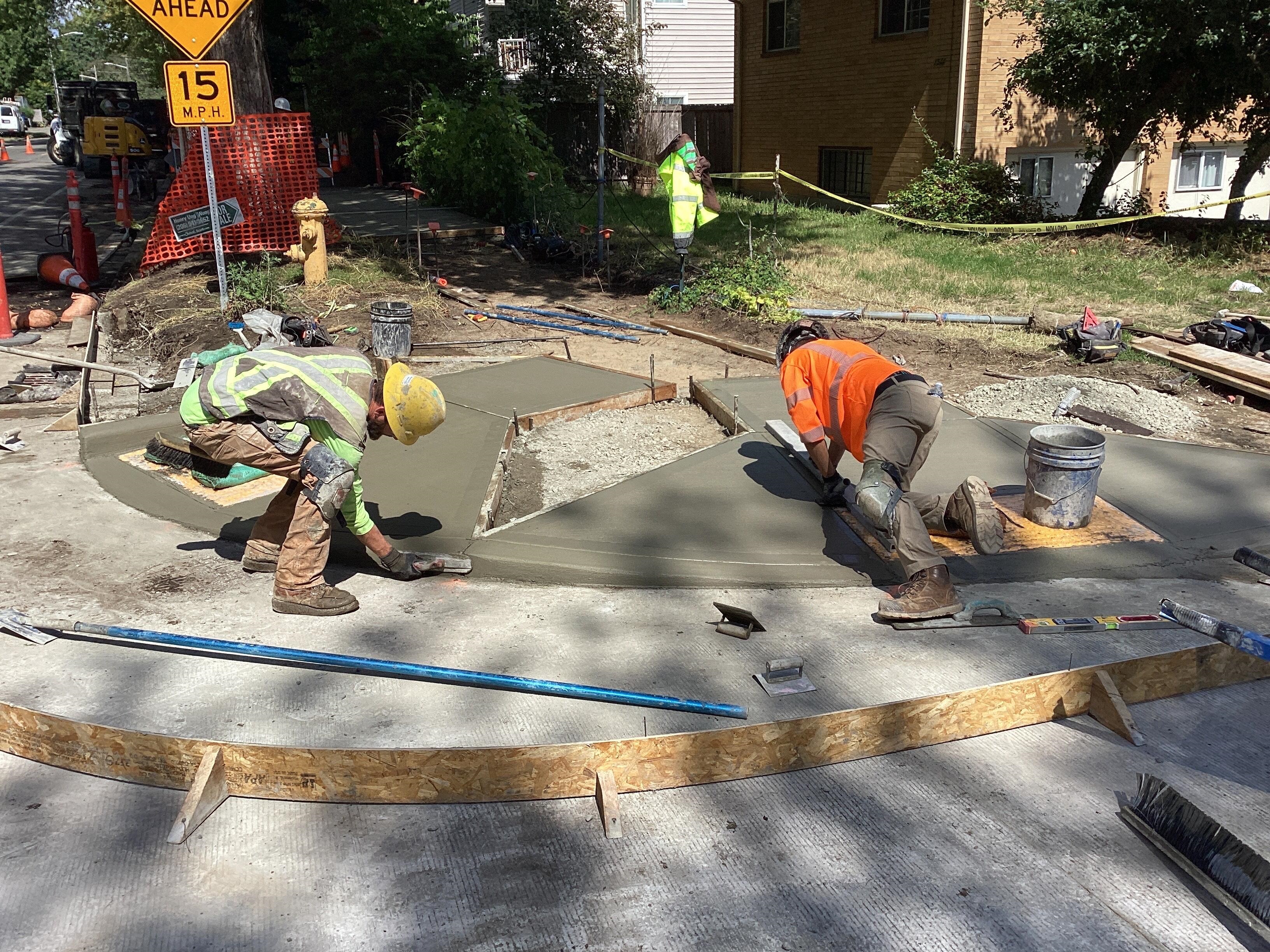 Crews installing new ADA-compliant curb ramps at the intersection of 15th Ave S & S Massachusetts St