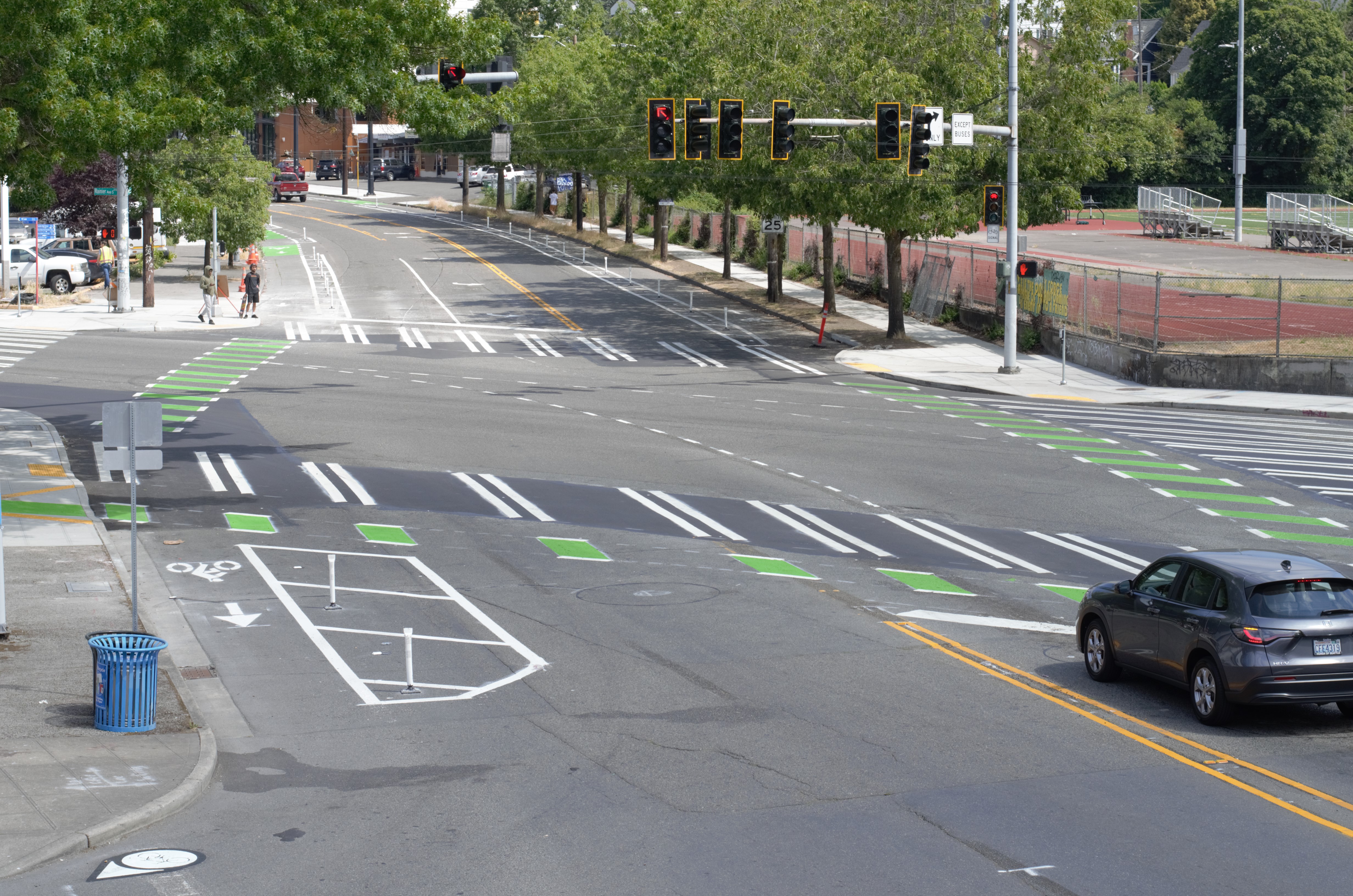 The updated intersection of MLK Jr Way S and Rainier Ave S with new protected bike lanes, crosswalks, bike signals, and clearer street markings.