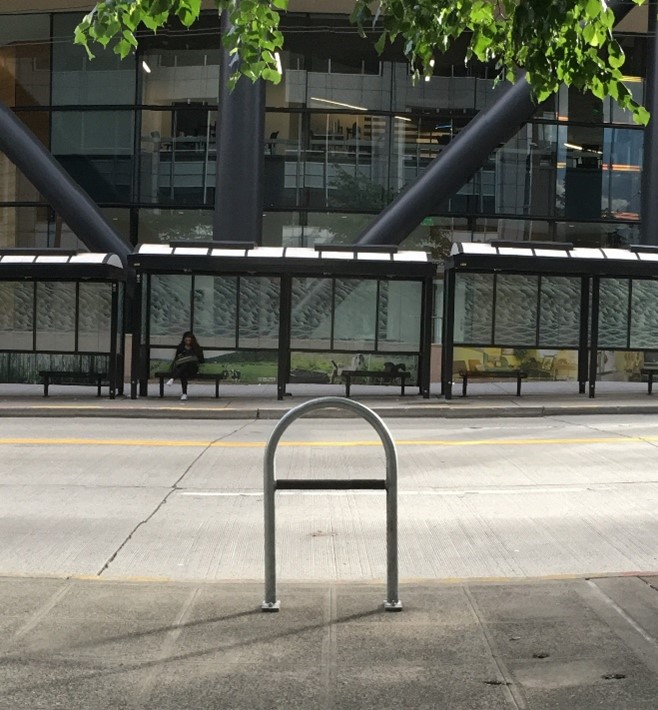 A photo of a U type bike rack installed on the sidewalk in downtown Seattle.