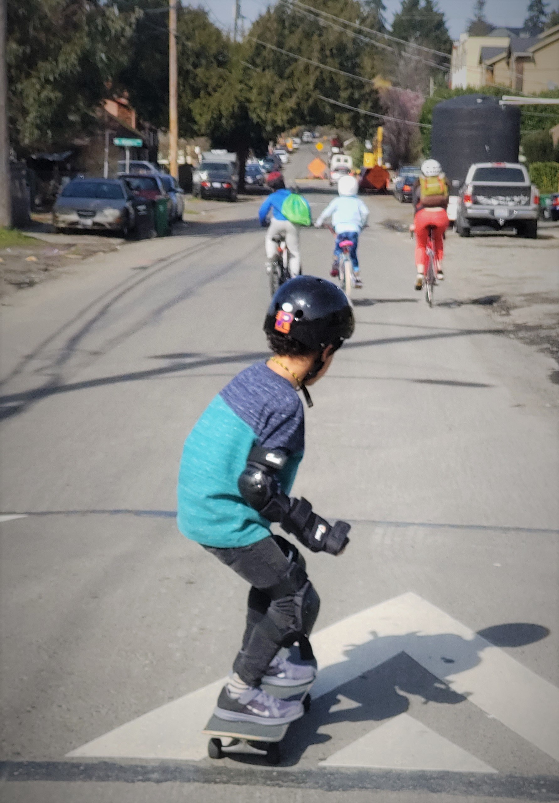 A kid riding their skateboard over a speed hump