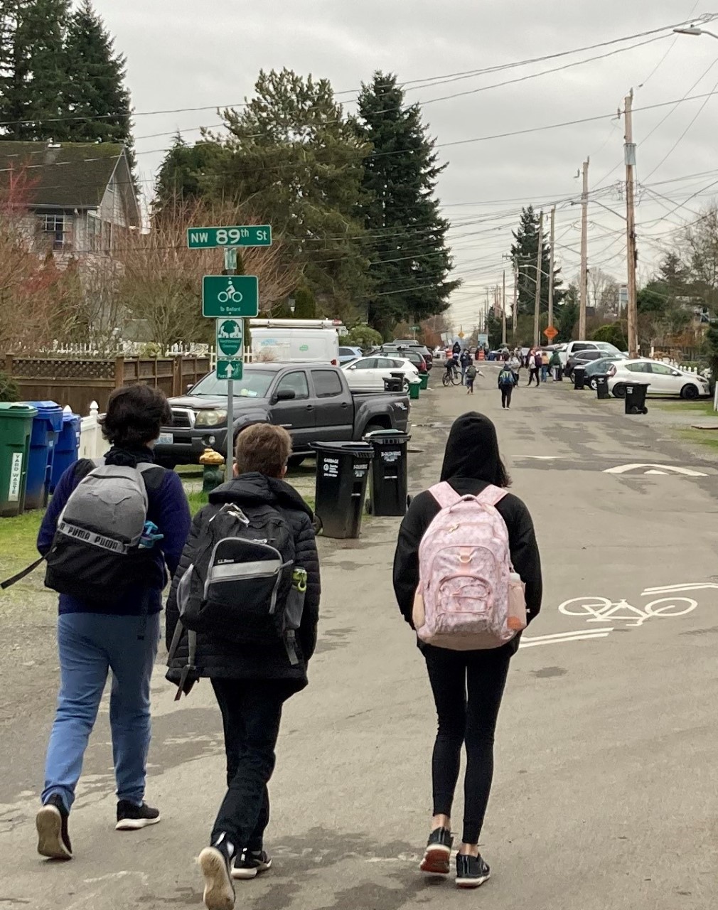 A group of students walk safely to school on a Stay Healthy Street in a residential neighborhood