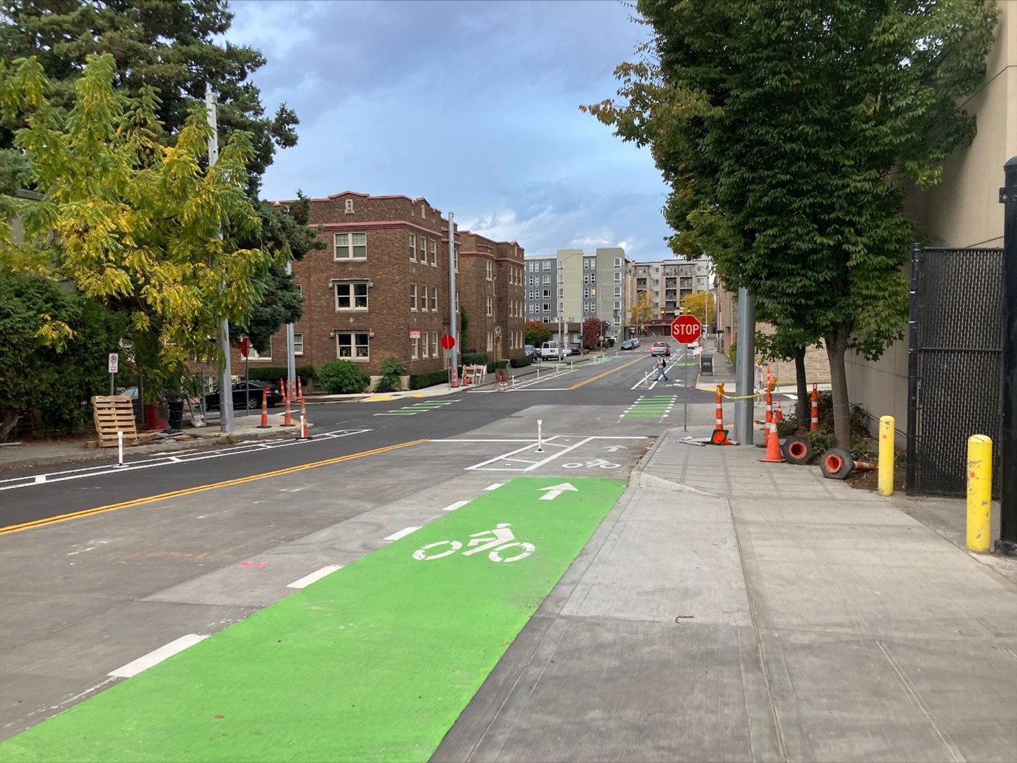 A picture showing the newly completed work on the 12th Ave NE & NE 43rd St Paving Project, including new bike lanes, sidewalk sections, curb ramps, and more!