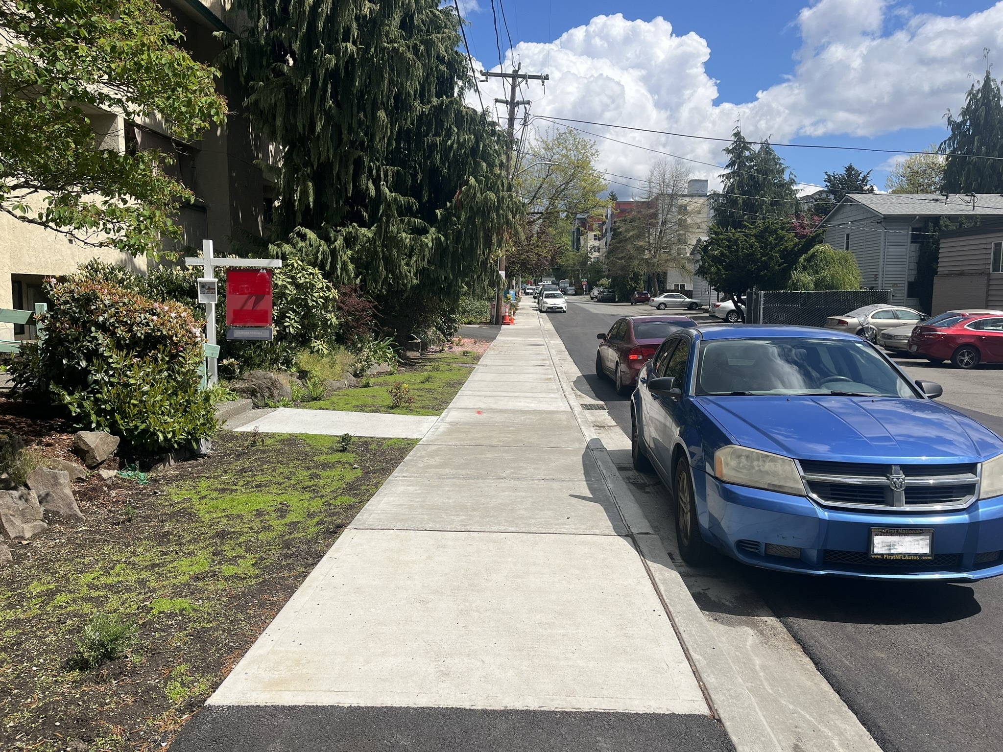 Photo shows the new sidewalk on the north side of NE 143rd St, between 30th Ave NE and 32nd Ave NE looking east