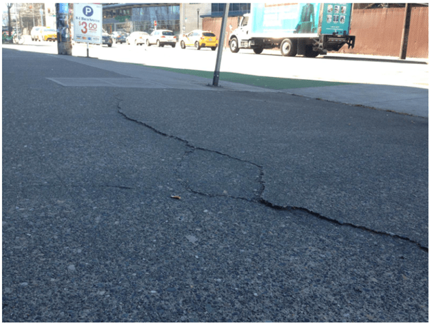 Parallel sidewalk crack.