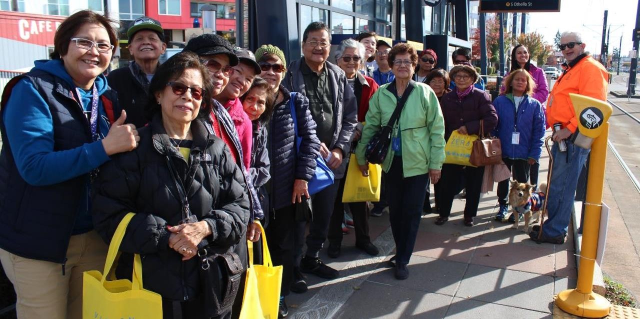 Photo of senior Seattle community members getting ready to ride the Link light rail train.