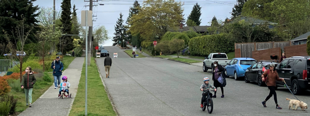 People of all ages travel on foot and on bikes up and down the hill on Genessee Street, which is closed to vehicle through traffic 
