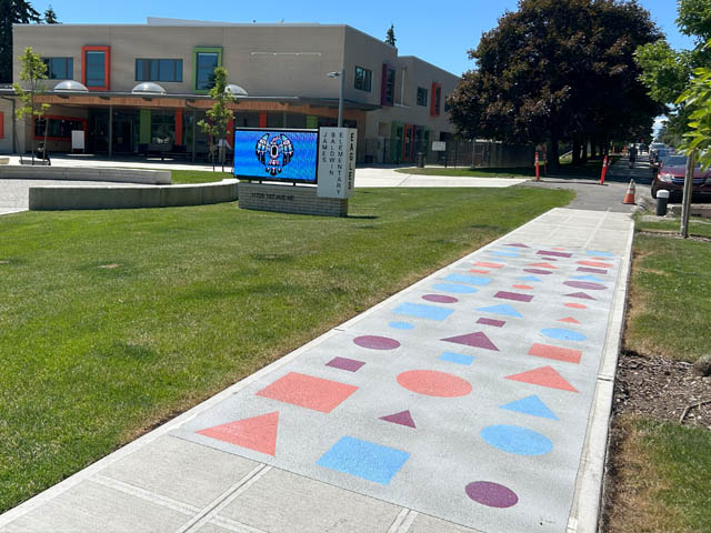 Front of James Baldwin Elementary School with design B on sidewalk, which looks like circles, squares and triangles