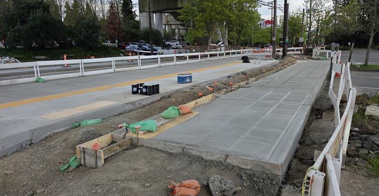 image shows the recently poured bus foundation that will house the new bus stop southbound on Eastlake Ave Eat Harvard Ave 