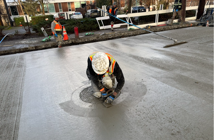 Image shows the team pouring new concrete in the street