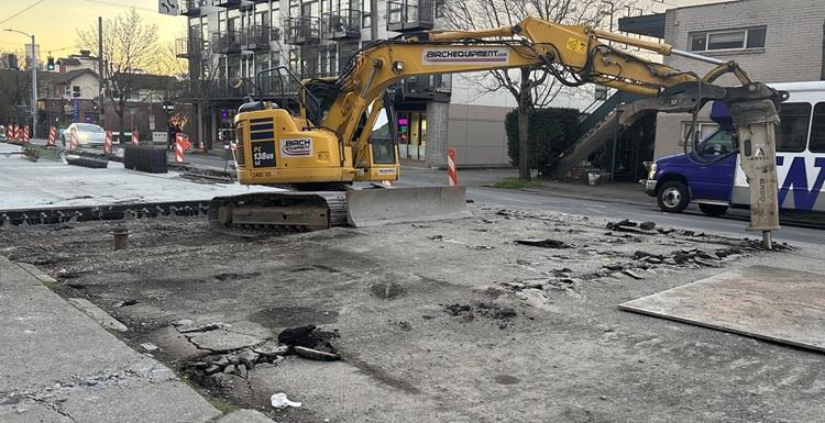 Image shows the team pouring new concrete for new pedestrian curb ramps in the University District