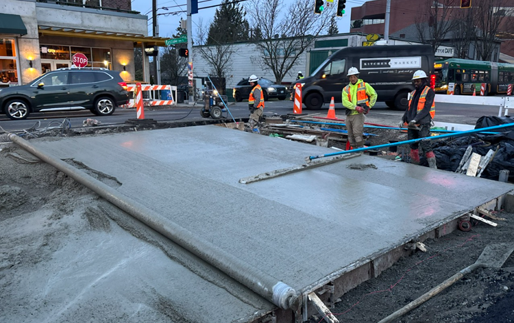 Image shows the team installing new road panels on Eastlake Ave E