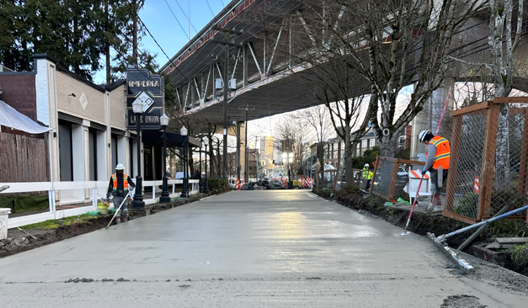 Image shows the team placing new concrete street panels near Imperia Lake Union