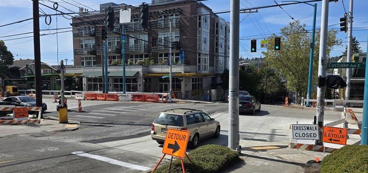 Image shows a large section of new sidewalk and pedestrian ramps recently completed along Eastlake Ave E
