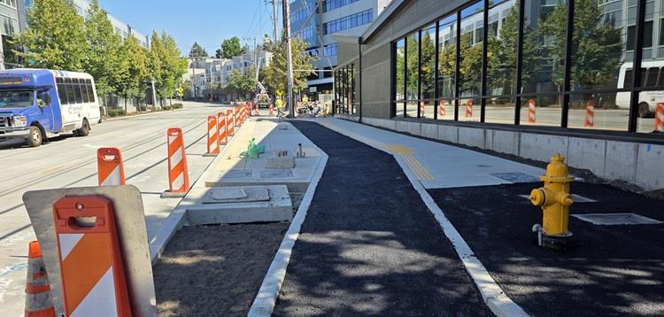 Image shows the work on the sidewalks and new bus stops near Victor Tavern on Eastlake Ave E
