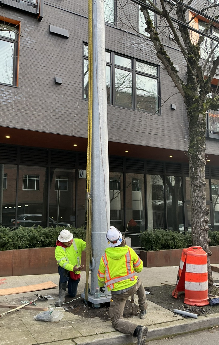 Image shows the placement of new poles in the University District. The poles will carry the electrical power for the RapidRide J Line buses