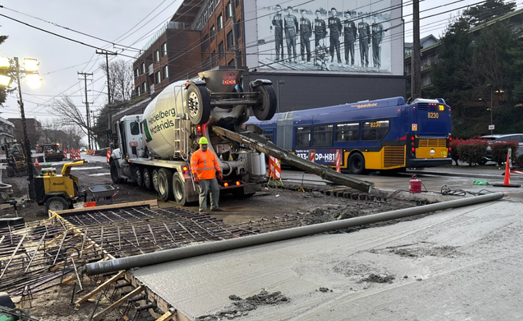 Image shows the team placing new concrete street panels on Eastlake Ave E near Aegis Living