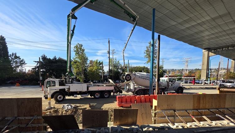 images shows our concrete truck pouring new concrete for the foundations for the retaining wall on Eastlake
