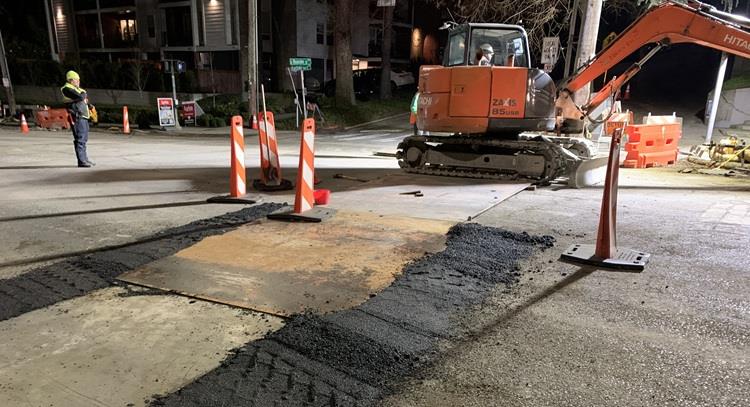 The image shows construction at E Roanoke St and Eastlake Ave E to install new electrical wires under the road.