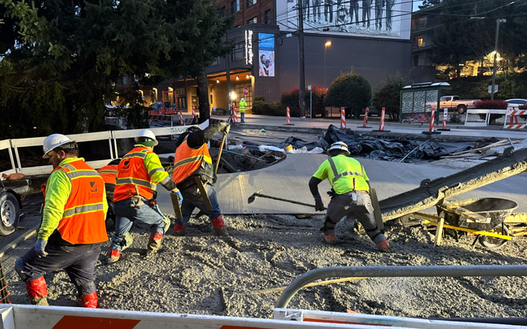 Image shows the pouring of concrete at the intersection of Eastlake Ave E and Yale Pl NE