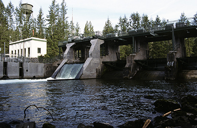 Water flows over a portion of a dam on the Cedar River