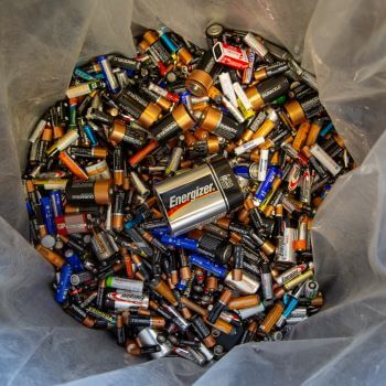 Used batteries in a recycling bin.
