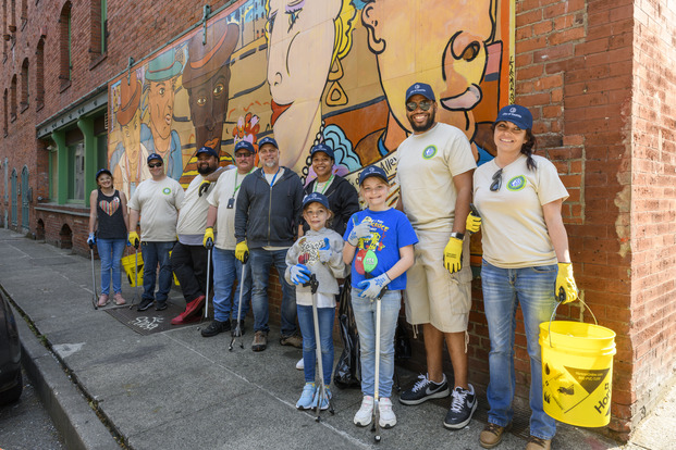 A group of volunteers in front of a mural