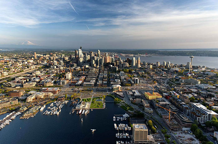 Aerial view of the Seattle skyline looking south, with the skyline and Mount Rainier in the background. Aerial view of the Seattle skyline looking south, with the skyline and Mount Rainier in the background.
