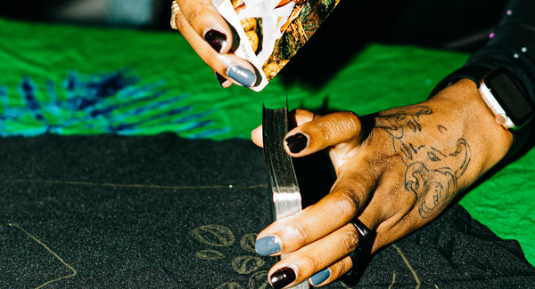 A Black woman's hands shuffling tarot cards
