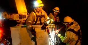 Crew at night in rain