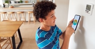 Boy with Smart Thermostat Photo