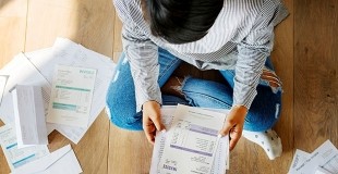 Customer with bills sitting on the floor