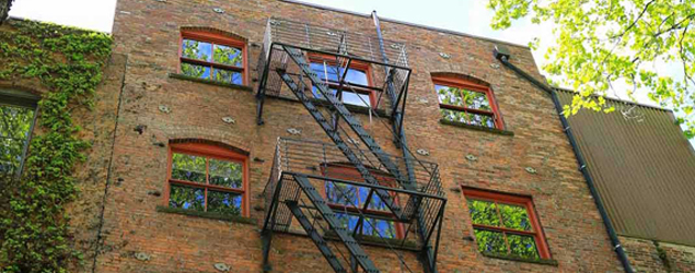 Brick apartment building with fire escapes