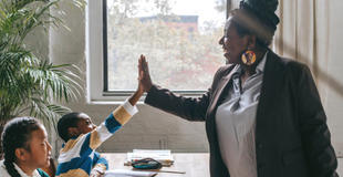 Image of African American teacher with students